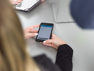 Image showing Elegant Woman Using Mobile Phone in office building