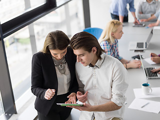 Image showing Two Business People Working With Tablet in office