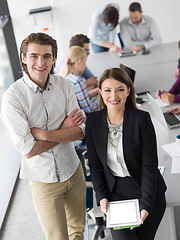 Image showing Two Business People Working With Tablet in office