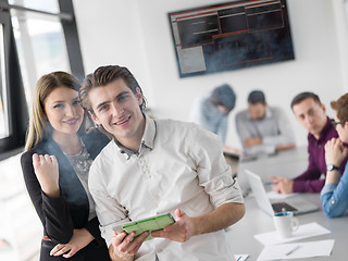 Image showing Two Business People Working With Tablet in office