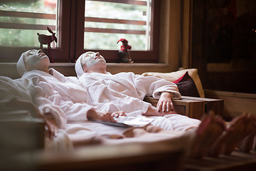 Image showing women is getting facial clay mask at spa