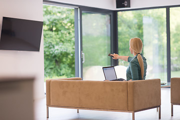 Image showing Young woman using laptop at home