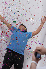 Image showing kid blowing confetti