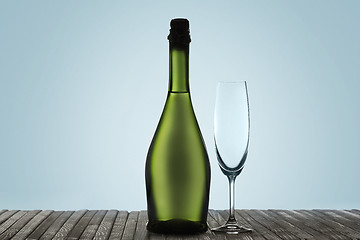 Image showing Glasses with champagne and bottle over sparkling holiday background