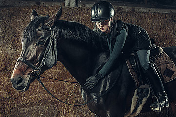 Image showing Image of happy female sitting on purebred horse