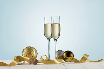 Image showing Glasses with champagne and bottle over sparkling holiday background