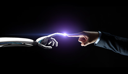 Image showing robot and human hand connecting fingers