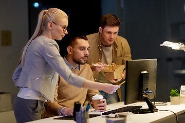 Image showing business team with computer working late at office