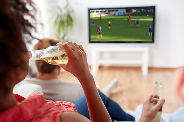 Image showing friends drinking beer and watching soccer on tv