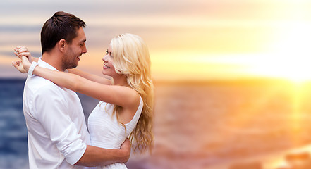 Image showing happy couple hugging over sea background