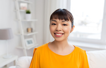 Image showing portrait of smiling young asian woman at home