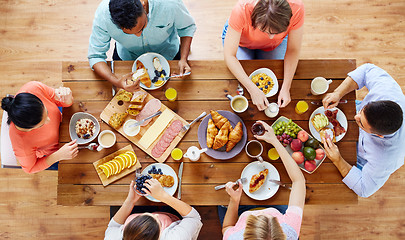 Image showing group of people having breakfast at table