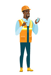 Image showing African-american builder holding a mobile phone.