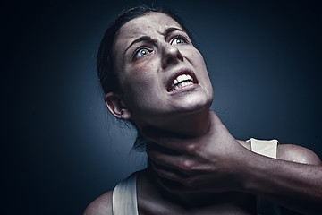 Image showing Home violence - young woman is choked by man\'s hand