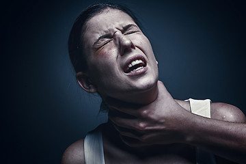 Image showing Home violence - young woman is choked by man\'s hand