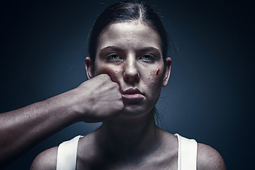 Image showing Male fist against kidnapped young woman in the background