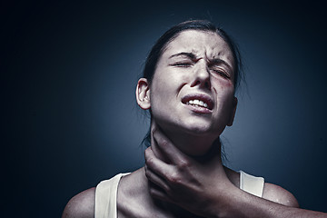 Image showing Home violence - young woman is choked by man\'s hand