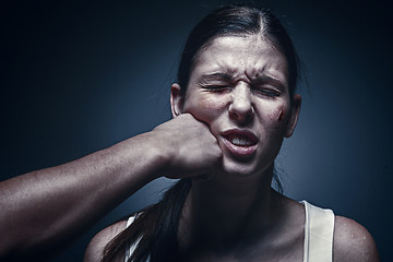 Image showing Male fist against kidnapped young woman in the background