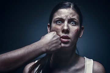 Image showing Male fist against kidnapped young woman in the background