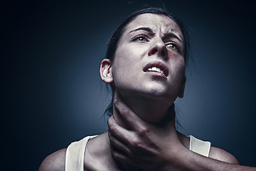 Image showing Home violence - young woman is choked by man\'s hand