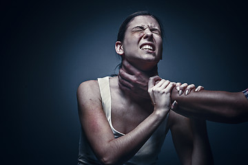 Image showing Home violence - young woman is choked by man\'s hand