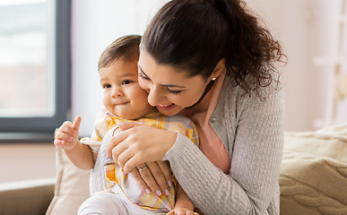 Image showing happy smiling mother with baby daughter at home