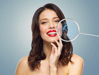 Image showing beautiful smiling woman with magnifying glass