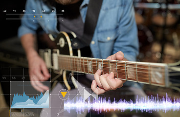 Image showing close up of man playing guitar at studio rehearsal