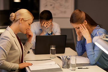 Image showing business team with laptop working late at office