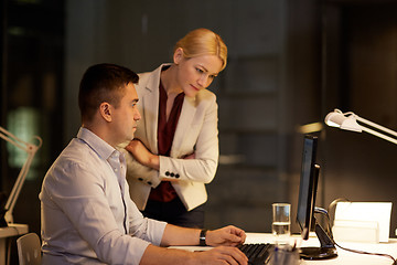 Image showing business team with computer working late at office