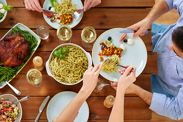 Image showing people at table with food eating pasta for dinner