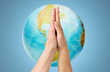 Image showing close up of senior and young woman touching hands