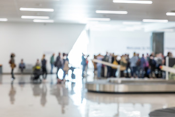 Image showing Blured image of people waiting for their luggage at airport arrival hall.