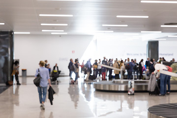 Image showing Blured image of people waiting for their luggage at airport arrival hall.