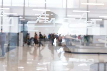 Image showing Blured image of people waiting for their luggage at airport arrival hall.