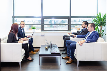 Image showing Business people sitting at working meeting in modern corporate office.