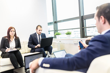 Image showing Business people sitting at working meeting in modern corporate office.