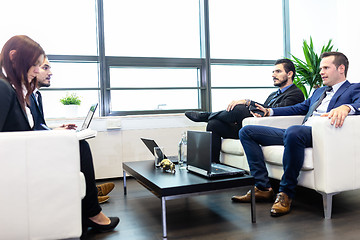 Image showing Business people sitting at working meeting in modern corporate office.