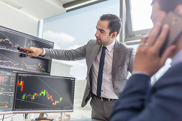 Image showing Stock brokers looking at computer screens, trading online.