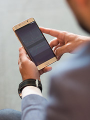 Image showing Close up of businessman using mobile smart phone.