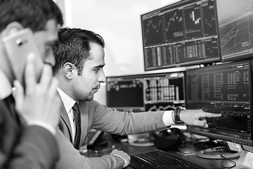 Image showing Stock brokers looking at computer screens, trading online.