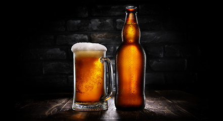 Image showing Beer in mug and bottle on black