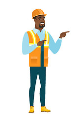 Image showing African-american builder pointing to the side.