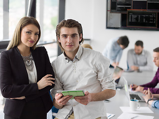 Image showing Two Business People Working With Tablet in office