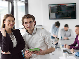 Image showing Two Business People Working With Tablet in office