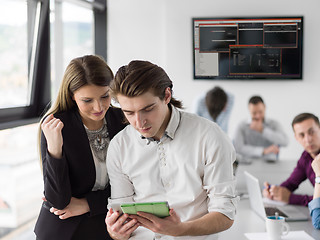 Image showing Two Business People Working With Tablet in office