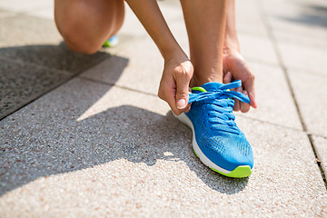 Image showing Woman trying shoelace