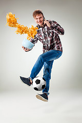 Image showing Portrait of young man with smart phone and football ball