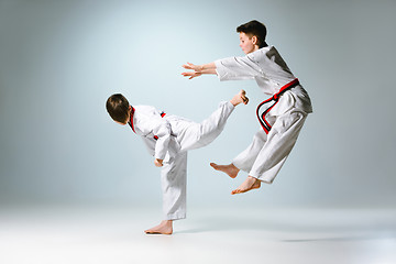 Image showing Studio shot of two of kids training karate martial arts