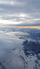 Image showing Top view on the Alps covered with snow and clouds